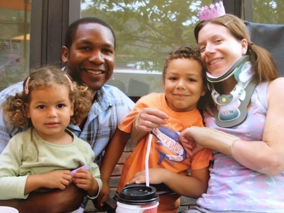 spinal cord injured Jacqui with her husband and children in garden