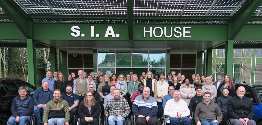 All staff team phot outside SIA house